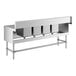 A Regency stainless steel underbar sink with (2) 12" drainboards and 2 faucets.