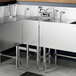 A Regency stainless steel underbar hand sink with faucet on a counter.
