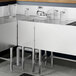 A Regency stainless steel underbar hand sink with a faucet on a black and white counter.