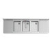 A stainless steel Regency underbar sink with three bowls and faucets.