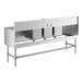A Regency stainless steel underbar sink with three bins and (2) 18" drainboards.