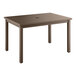 A brown Grosfillex outdoor dining table with a wooden top and legs.