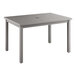 A Grosfillex Sigma volcanic black rectangular outdoor dining table on a patio.
