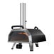 A black and silver Ooni Karu 16 outdoor pizza oven with a fire inside.
