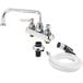 A T&S chrome deck-mounted faucet with hose and self-closing sprayer.