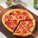 A pepperoni pizza on a wood surface with cheese and Beyond Meat plant-based pepperoni.