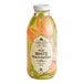 A Harney & Sons glass bottle of white peach matcha iced tea with a label.