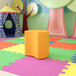 A colorful playroom with a yellow Flash Furniture Nicholas Moon Modular Ottoman.