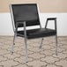 A Flash Furniture black vinyl bariatric reception arm chair with metal legs.