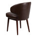 A Flash Furniture brown leather chair with wooden legs.