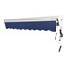 An Awntech navy blue and white retractable patio awning with a cord.