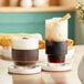 Two Acopa Lore rocks glasses filled with coffee on a table.