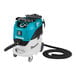 A Makita wet/dry vacuum cleaner on wheels.
