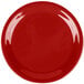 A close-up of a red Carlisle Sierrus melamine pie plate with a white rim.