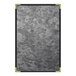 A close-up of a steel brushed metallic plate with a gold corner.
