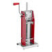 A red and silver Tre Spade manual vertical sausage stuffer.