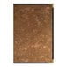 A brown metallic menu cover with a black border on a brown surface.