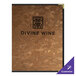 A brown metallic menu cover with black text on a table in a fine dining restaurant.