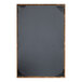 The corner of a black menu cover with a brushed metallic gold frame.