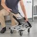 A man pushing a Lavex aluminum folding platform truck.