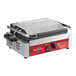 An Avantco commercial panini grill with a red and black handle.