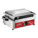 An Avantco commercial panini grill with a red and black handle and silver lid.