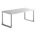 An Avantco stainless steel single deck overshelf on a white rectangular table.