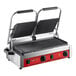 An Avantco commercial panini grill with two black and red grooved plates on a table.