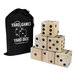 A black bag with white text containing a stack of wooden dice with black dots.