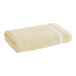 A beige 1888 Mills Fibertone bath towel.