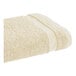 A beige Fibertone pool/bath towel with a white stripe on the edge.