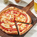 A pizza with a slice missing, topped with Miyoko's Liquid Vegan Mozzarella, on a wooden board.