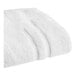 A close-up of a white Sweet South bath mat.