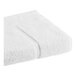 A close-up of a white 1888 Mills True Comfort bath mat folded in half.