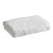 A rolled white 1888 Mills Millennium bath sheet.