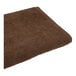 A brown 1888 Mills Coco bath towel.