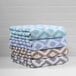 A stack of teal diamond jacquard pool towels.
