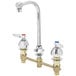 A chrome T&S medical lavatory faucet with lever handles.