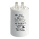 A white cylindrical American Range A91032 capacitor with black text.