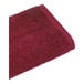 A red 1888 Mills Millennium bath towel.