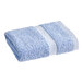 A blue 1888 Mills Fibertone hand towel with a white stripe folded up.