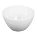 An Elite Global Solutions round melamine bowl with a cream reactive glaze on a white background.