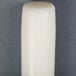 A 15 inch ivory Will & Baumer taper candle on a gray surface.