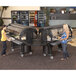 Two women using a Cambro Versa Food and Salad Bar on wheels.