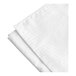 A white bed skirt with tone on tone stripes.