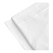 A folded white 1888 Mills Flourish twin XL microfiber fitted sheet on a white surface.