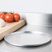 An American Metalcraft aluminum pizza pan on a counter.