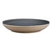 A white porcelain deep coupe plate with a blue rim.