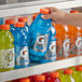 A hand holding a close up of a blue Gatorade Cool Blue sports drink bottle.