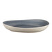 A white porcelain deep plate with a blue and white organic rim.